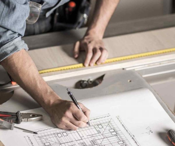 closeup of man working over building plans